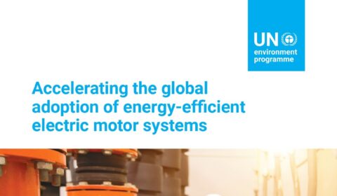 A worker in a white helmet inspects large blue and orange industrial electric motor systems in a facility; UN Environment Programme policy guide cover text is shown.
