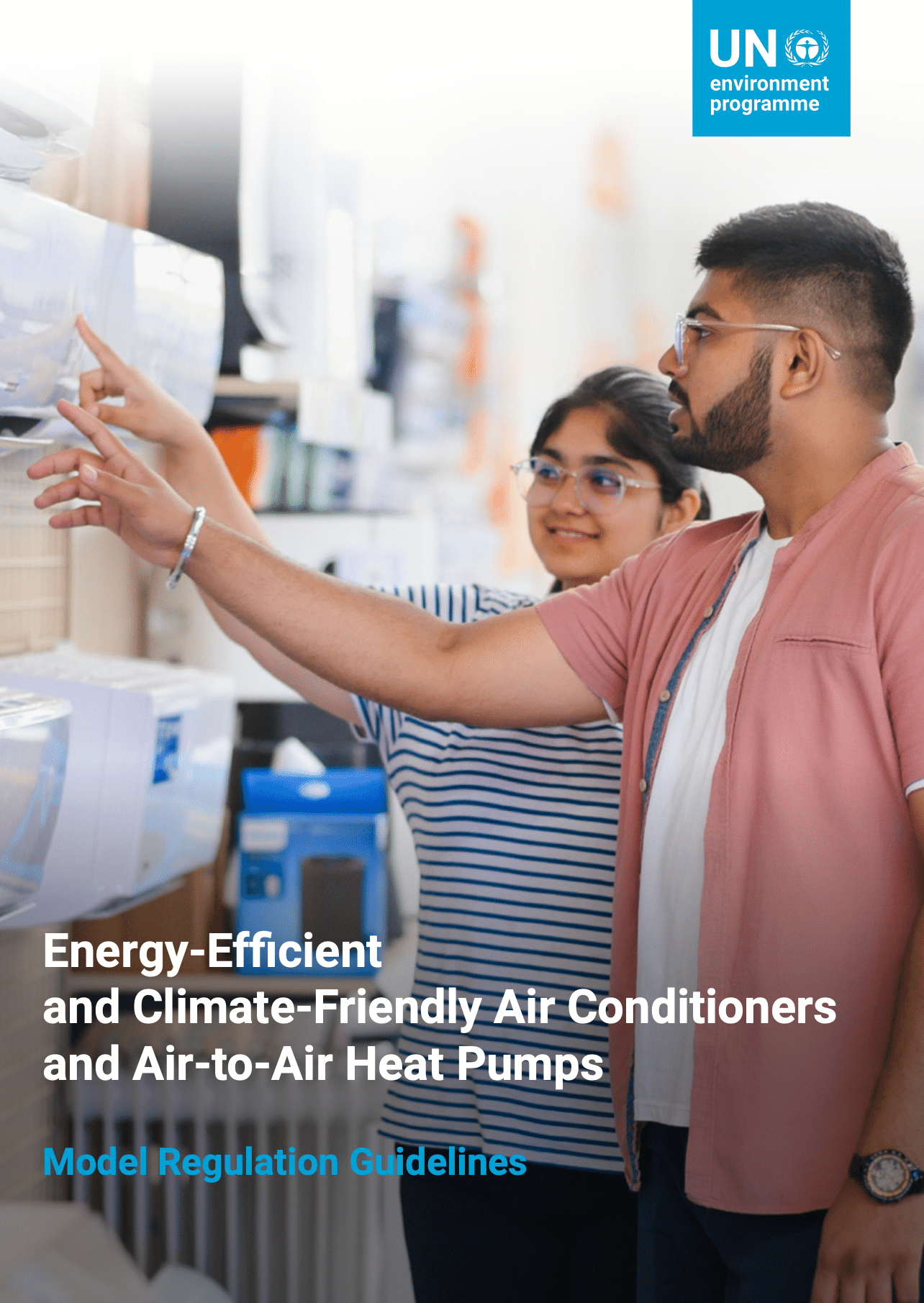 Two people examine air conditioners in a store. The cover includes the UN Environment Programme logo and text about energy-efficient and climate-friendly air conditioners and heat pumps, with Model Regulation Guidelines highlighted.