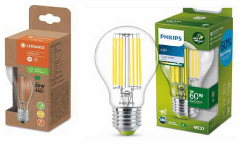 Two LED light bulbs in their packaging: one in a brown-orange box labeled LEDVANCE, and one in a green-blue box labeled PHILIPS. Both packages display bulbs with visible yellow filaments.